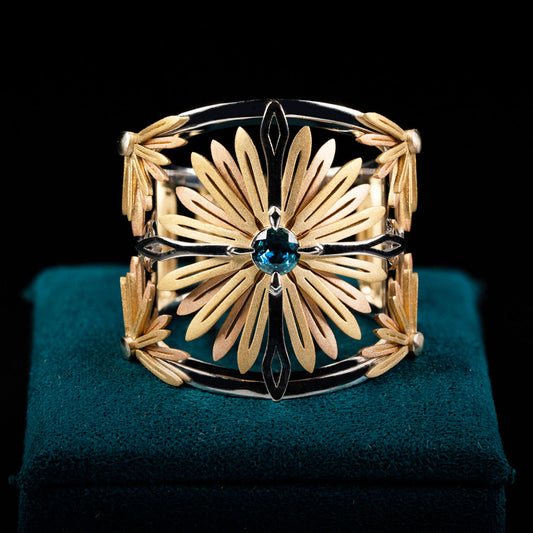 Luxury Sospiro di Echinacea ring handcrafted in 18K ethical gold, adorned with a sapphire—an elegant tribute to the healing strength of the Echinacea flower. Designed by Riccardo Contini