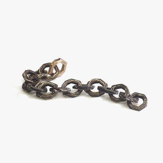 Luxury Braci bracelet handcrafted in 18K rose ethical gold with burned engravings, a symbol of enduring flame and artistic resilience by Riccardo Contini