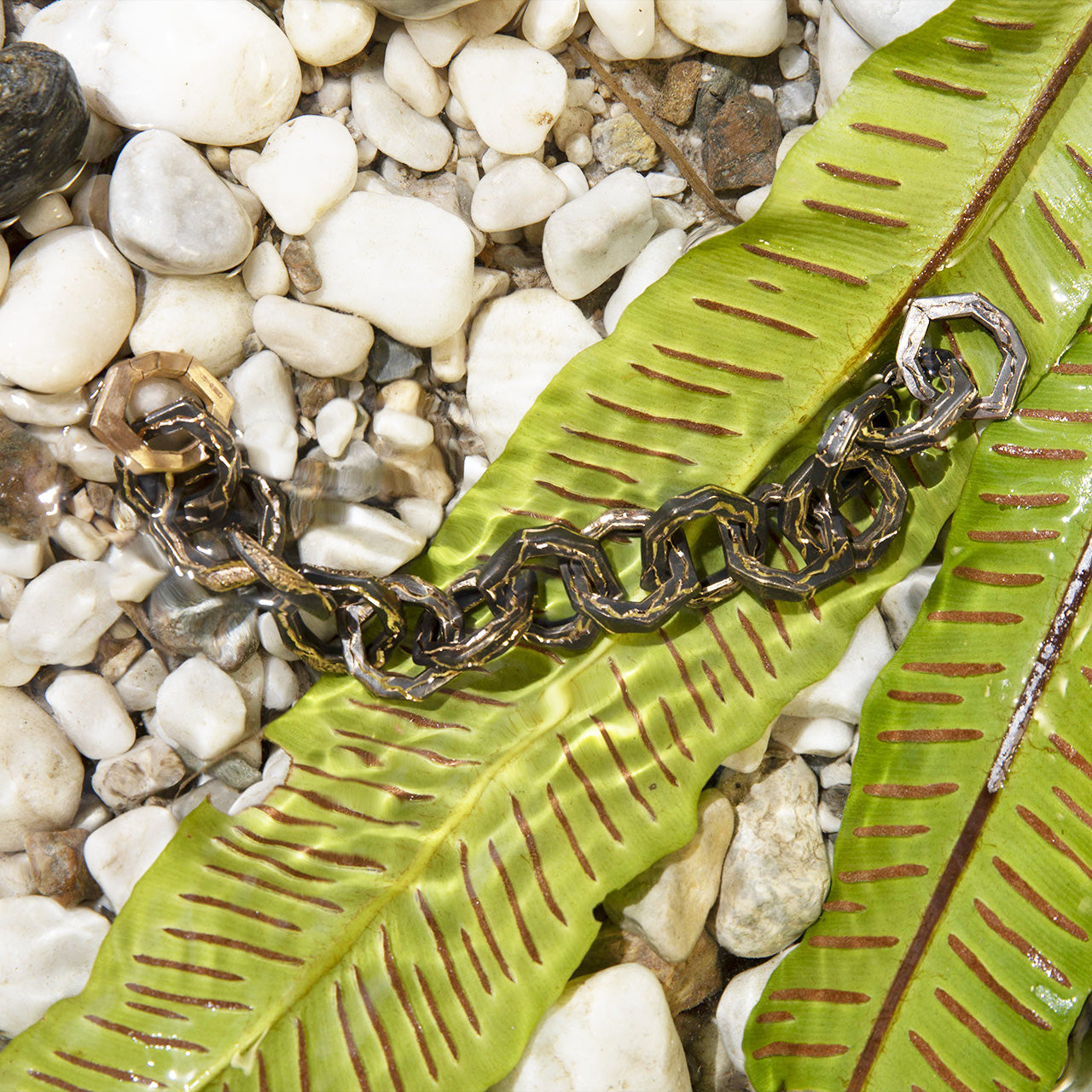 Luxury Braci bracelet handcrafted in 18K rose ethical gold with burned engravings, a symbol of enduring flame and artistic resilience by Riccardo Contini