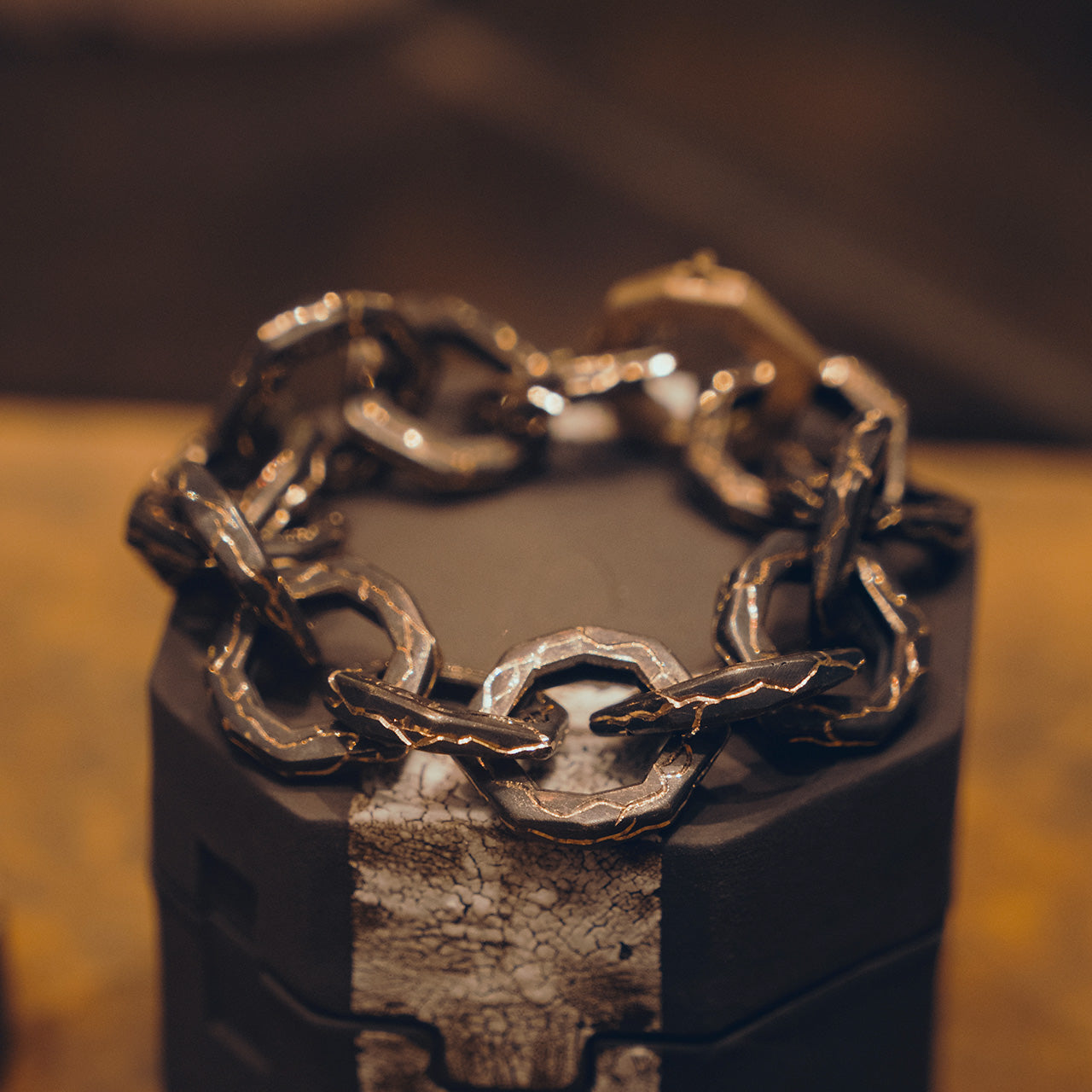 Luxury Braci bracelet handcrafted in 18K rose ethical gold with burned engravings, a symbol of enduring flame and artistic resilience by Riccardo Contini