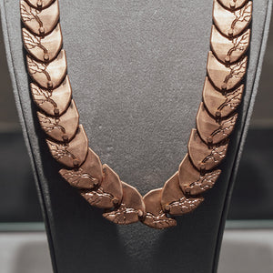 Luxury Cuore di Moringa necklace handcrafted in 18K rose FairTrade ethical gold, featuring intricate burned and engraved details—designed by Riccardo Contini