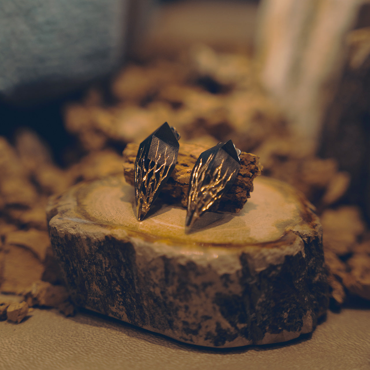 Luxury Eclissi Infranti Distanti earrings handcrafted in 18K yellow ethical gold, capturing the raw beauty of nature with tribal engravings and bold asymmetry – designed by Riccardo Contini
