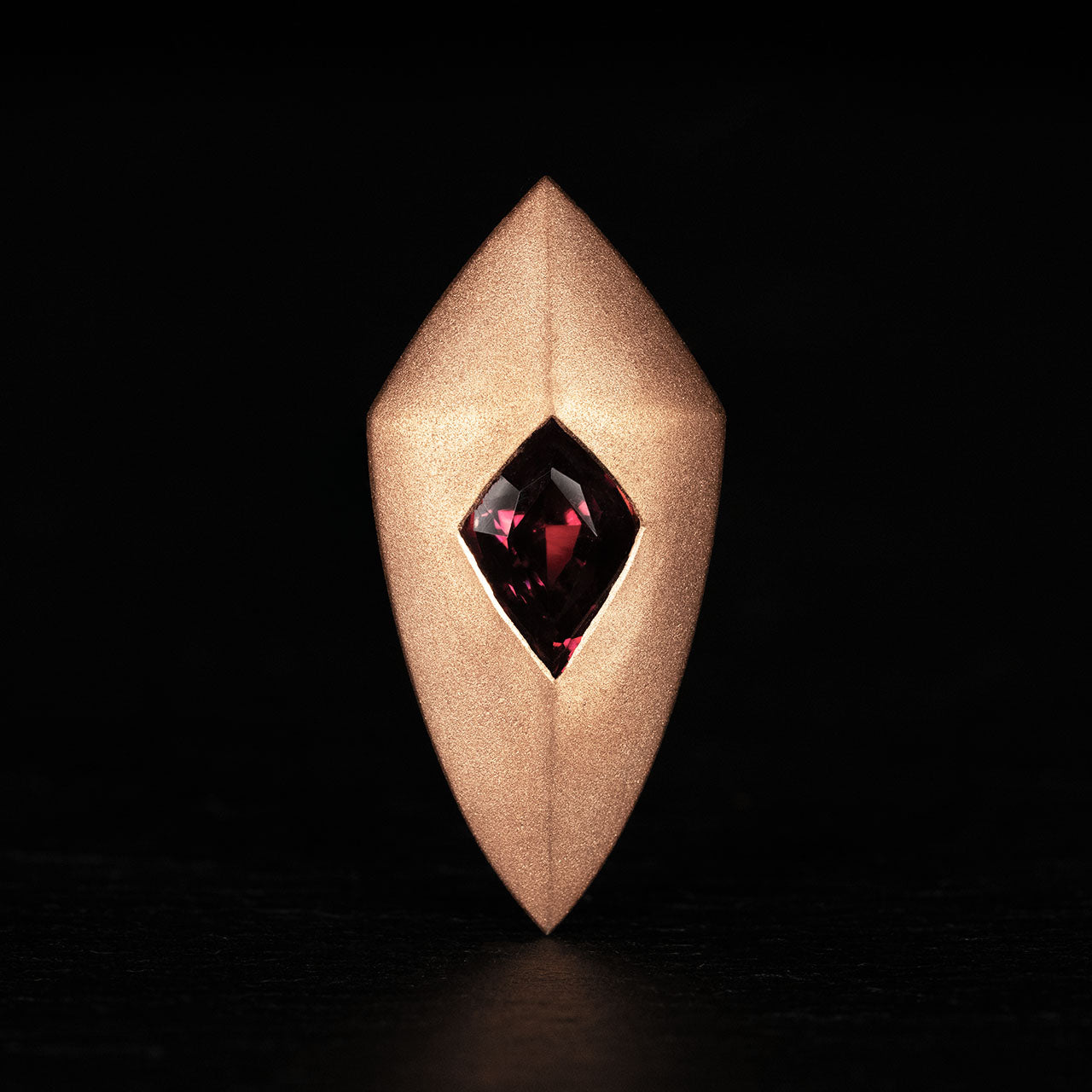 Luxury Freccia Scarlatta pendant handcrafted in 18K satin-finished rose ethical gold, featuring a striking red garnet—an arrow of passion, energy, and direction by Riccardo Contini