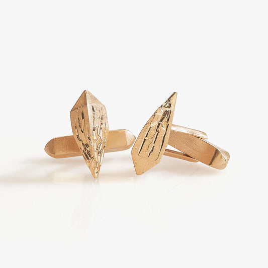 Luxury Infranti Distanti cufflinks handcrafted in 18K rose ethical gold with engraved details, capturing the raw beauty of nature—like ice cracking upon an arrow's flight. Designed by Riccardo Contini