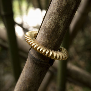 Luxury Sole Tribale bracelet handcrafted in 18K yellow ethical gold with subtle engravings, a radiant tribute to the sun’s strength and symbolism – designed by Riccardo Contini