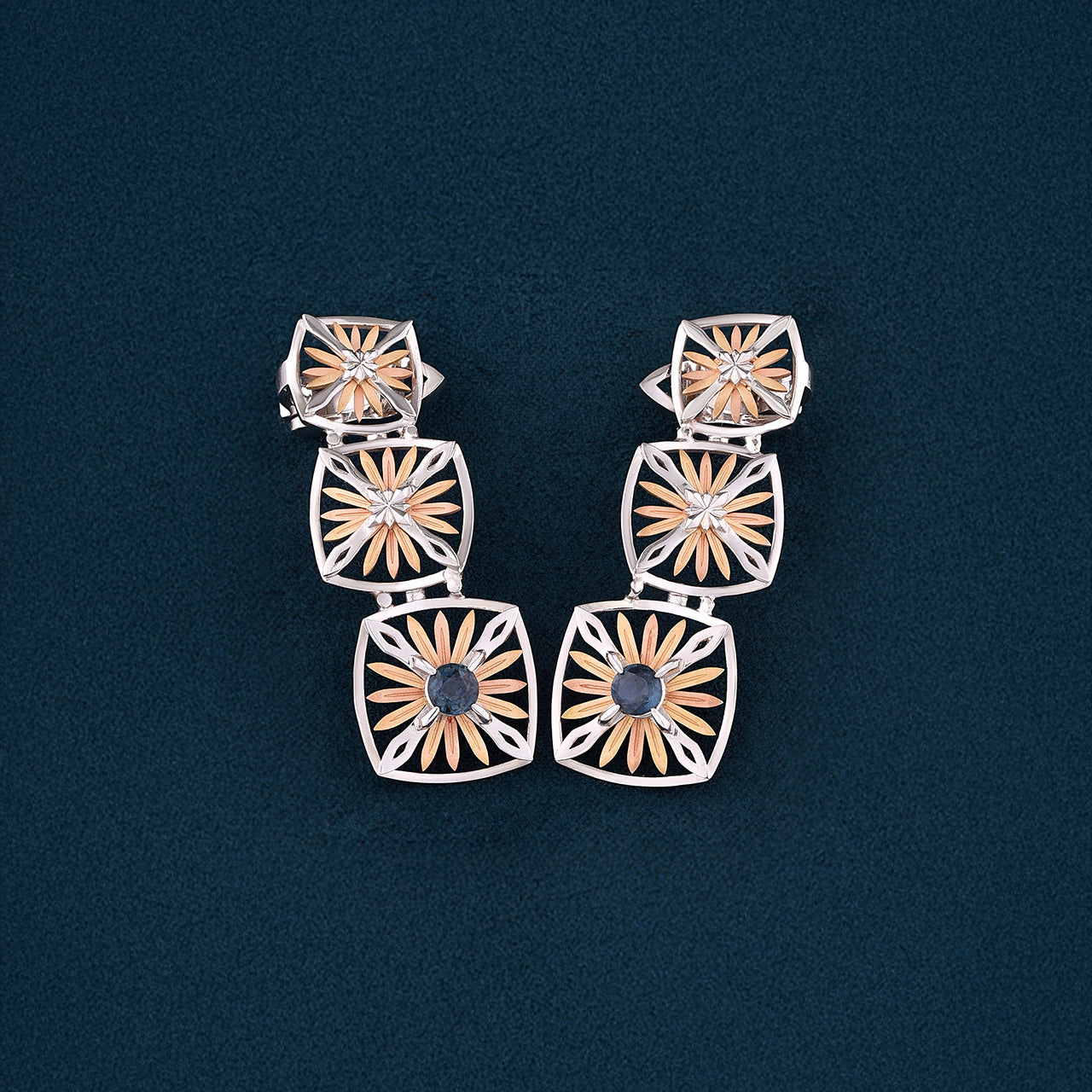 Inspired by the Echinacea flower, symbolizing strength and healing, the Sospiro di Echinacea earrings are limited-edition, handcrafted luxury pieces in 18K rose and white ethical gold adorned with sapphires, designed by Riccardo Contini.​