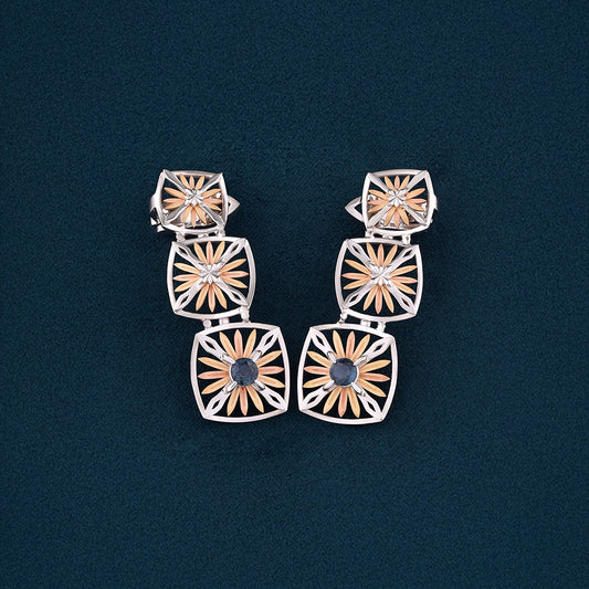 Inspired by the Echinacea flower, symbolizing strength and healing, the Sospiro di Echinacea earrings are limited-edition, handcrafted luxury pieces in 18K rose and white ethical gold adorned with sapphires, designed by Riccardo Contini.​