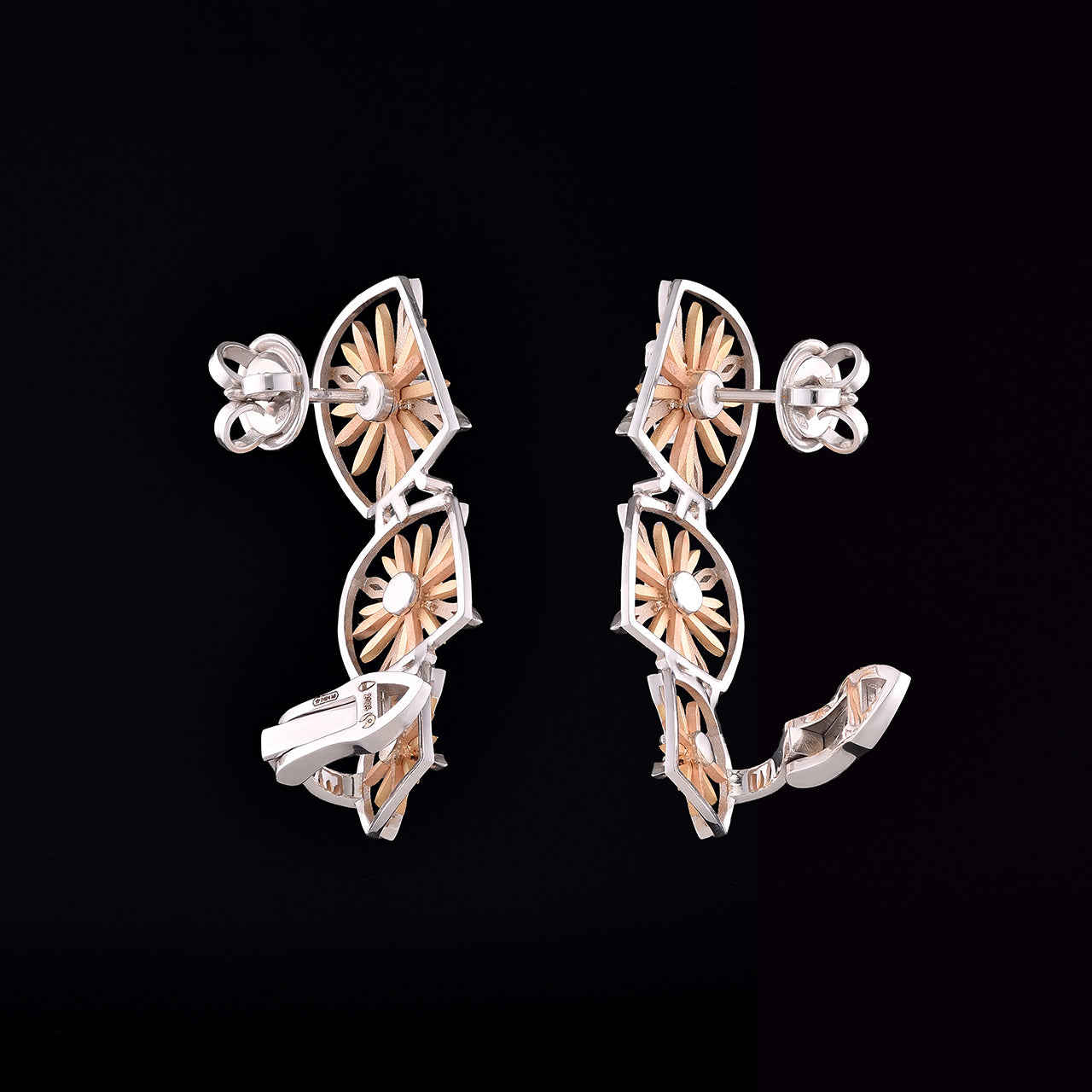 Inspired by the Echinacea flower, symbolizing strength and healing, the Sospiro di Echinacea earrings are limited-edition, handcrafted luxury pieces in 18K rose and white ethical gold adorned with sapphires, designed by Riccardo Contini.​