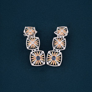 Inspired by the Echinacea flower, symbolizing strength and healing, the Sospiro di Echinacea earrings are limited-edition, handcrafted luxury pieces in 18K rose and white ethical gold adorned with sapphires, designed by Riccardo Contini.​