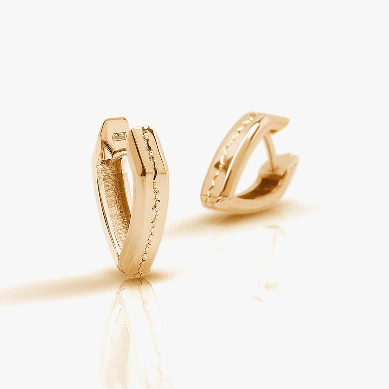 Luxury Terra che Cammina earrings handcrafted in 18K rose ethical gold with engraved details, embodying the essence of the earth in motion—designed by Riccardo Contini